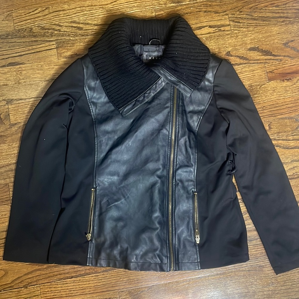 Black jacket with designs of faux leather on the front and back.